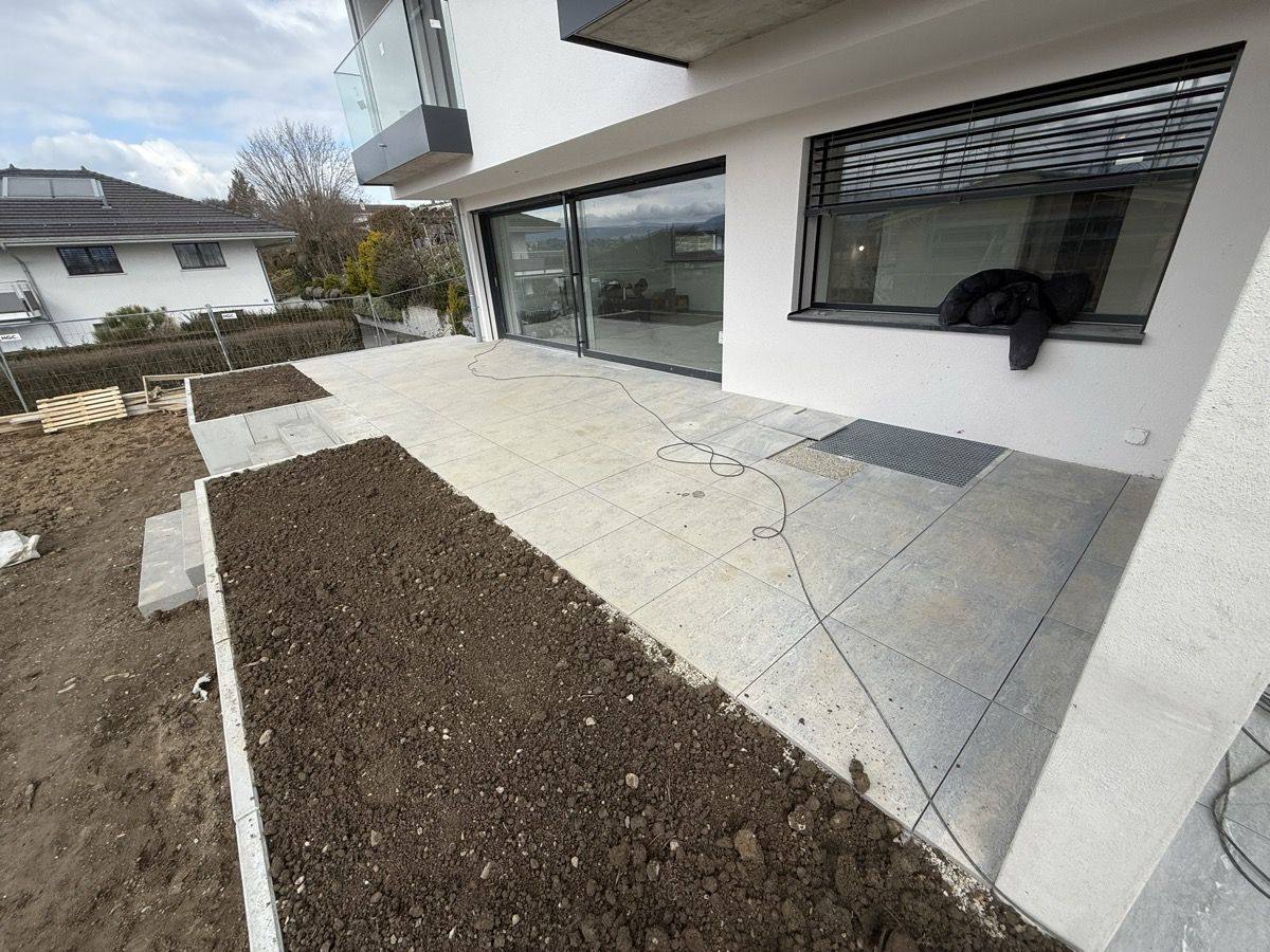 Aménagement extérieur et terrasse en dalles d'une villa à Ecublens